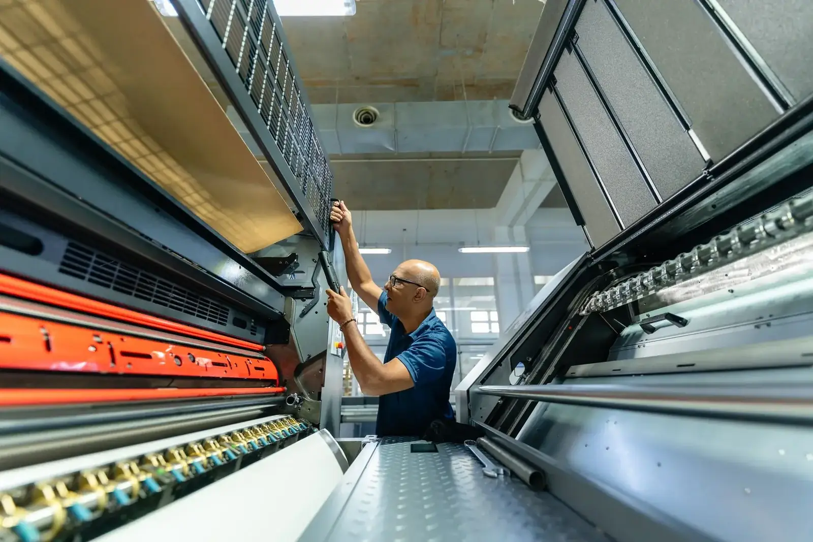 Intergraph technician working inside a printing machine