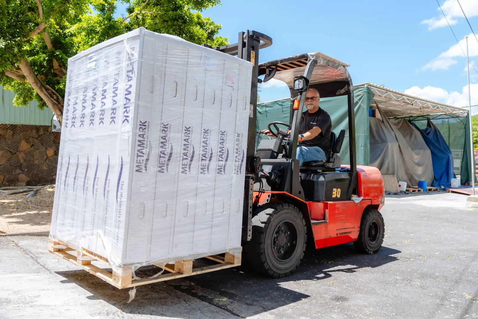 Forklift delivering a pallet of Metamark vinyl to Intergraph