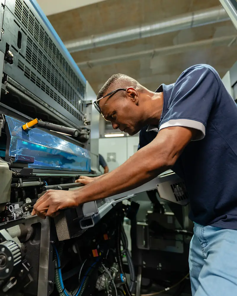 Intergraph technician setting up a printing unit of a Heidelberg Speedmaster CX 104
